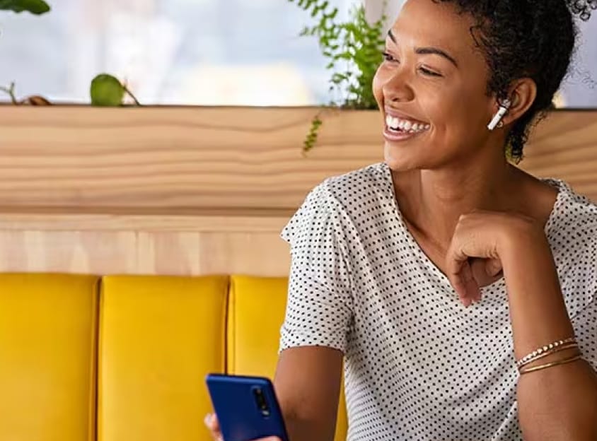 Seated woman laughing on a call